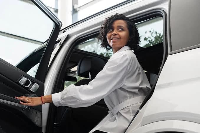 A business passenger stepping out of a car