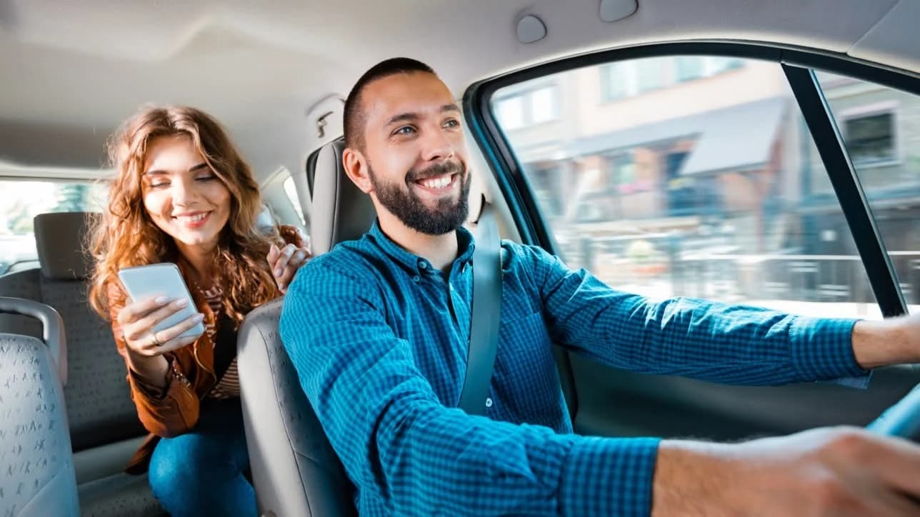 A smiling Watling Cars driver chatting with his passenger